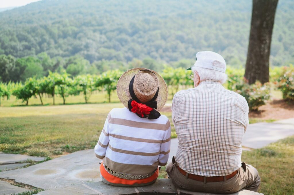 elderly couple facing a forest - can you get travel insurance if you are over 80
